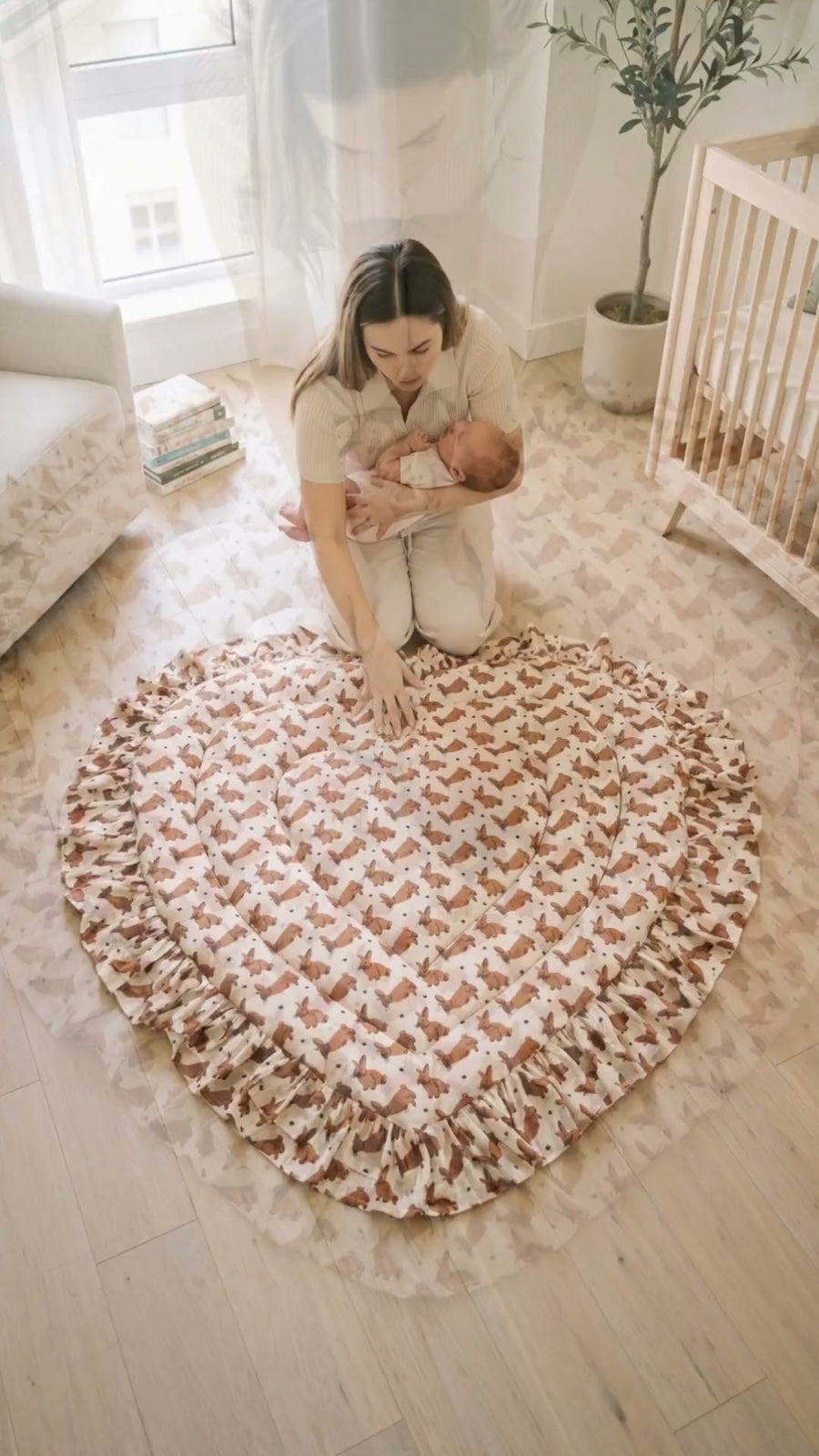 A baby sleeping on the Kabira heart quilted mat in a sunlit nursery