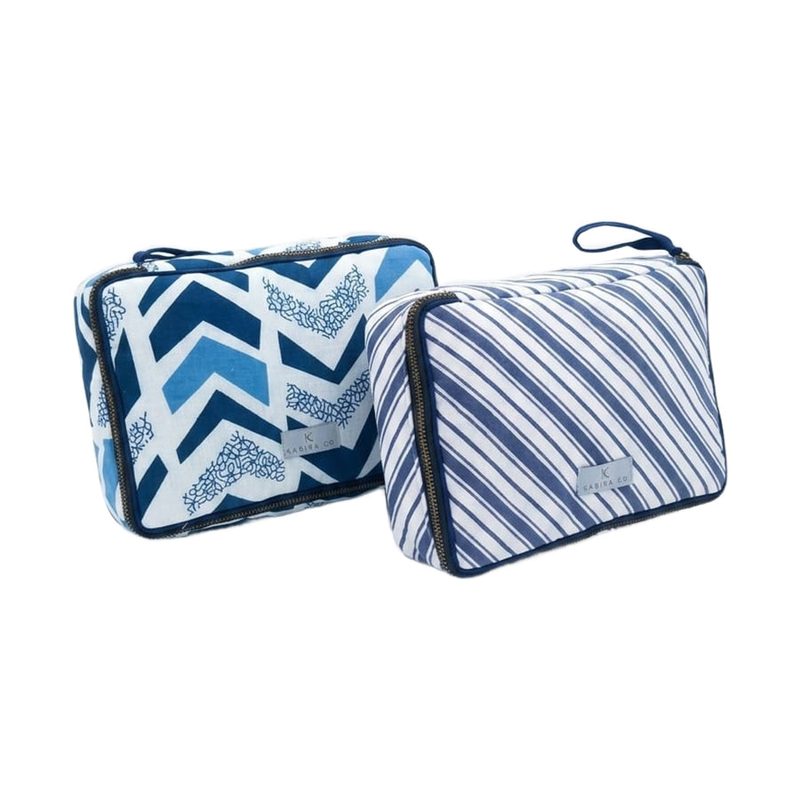 Kabira travel pouch shown in both navy stripe and indigo chevron prints